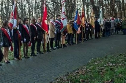 Grupowe zdjęcie uczestników uroczystości z flagami polski i sztandarami